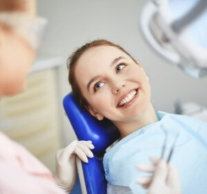 woman smiling pointing at teeth