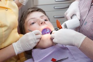 boy at dentist with mouth open