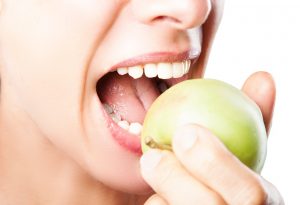 Woman eating an apple