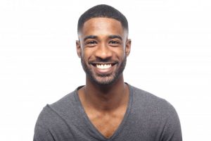 man smiling with straight white teeth
