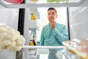 person looking in their refrigerator